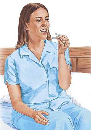 Woman in blue scrubs sitting on dental chair, smiling while holding dental floss for TMD treatment.