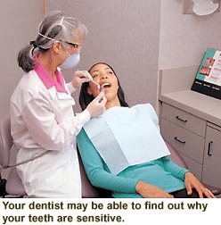 Dentist examining patient's teeth to diagnose sensitive tooth causes in Tullahoma.