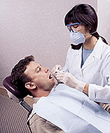 Dentist performing scaling and root planing treatment on patient in Tullahoma dental office.
