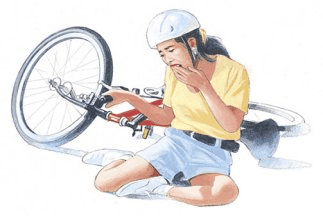 Young cyclist in yellow shirt and helmet examining injured arm after bike accident, illustrating dental trauma injury risk.